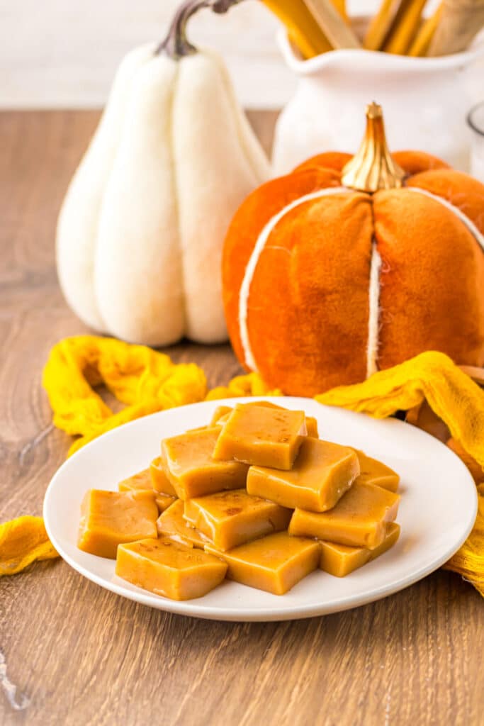 Plate of homemade pumpkin spice caramels cut into bite-sized squares