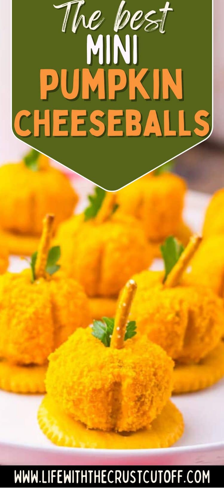 Close-up of mini pumpkin cheeseballs coated in crushed cheese curls with pretzel stick stems.