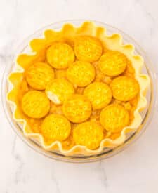 Mock apple pie topped with round cracker slices arranged in a pattern before baking