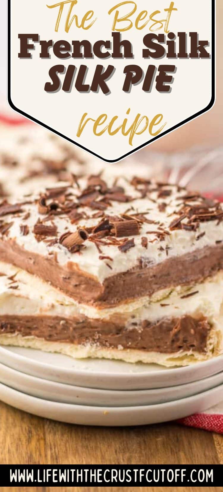 A slice of French silk slab pie with layers of chocolate filling and whipped cream on top, sprinkled with chocolate curls.