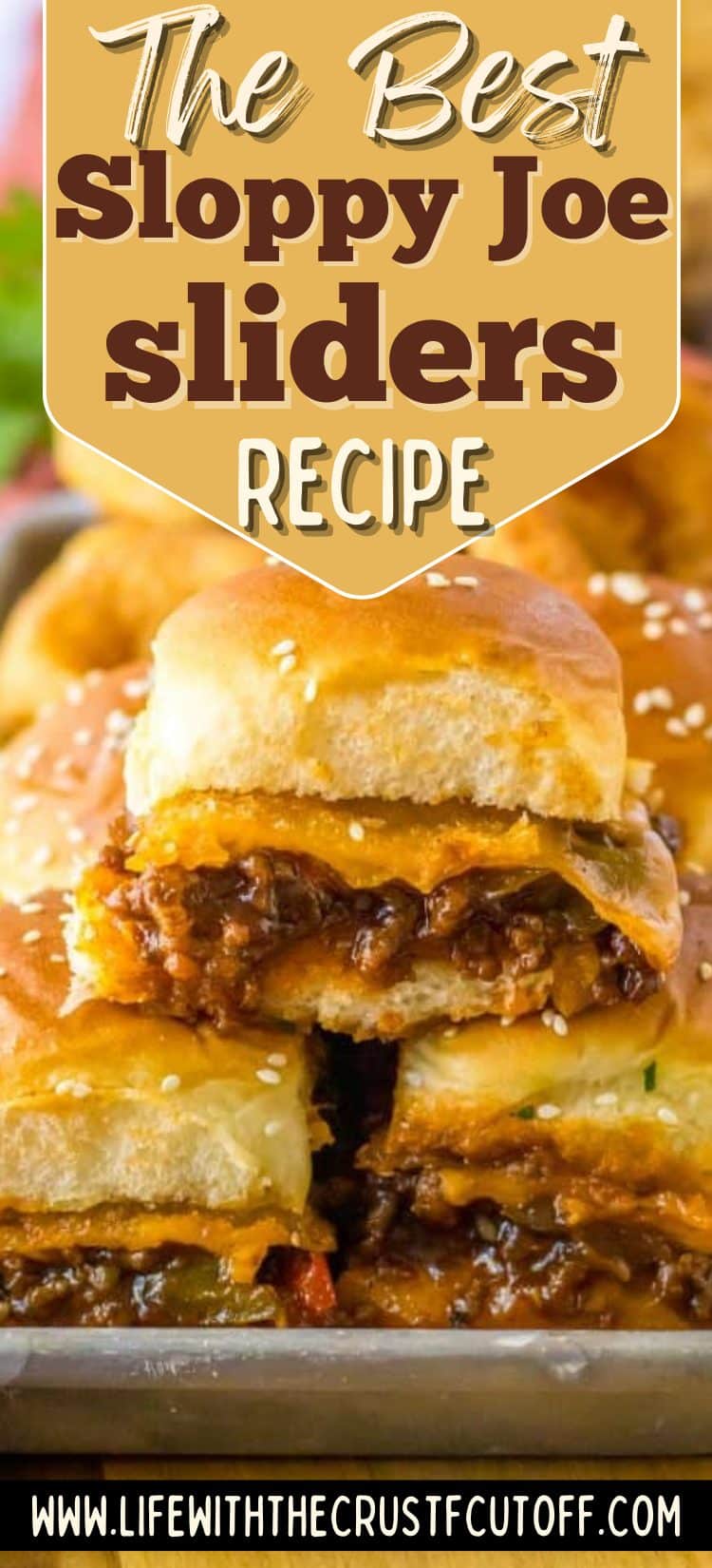 Close-up of cheesy sloppy joe sliders baked on soft golden rolls and pulled apart for serving.