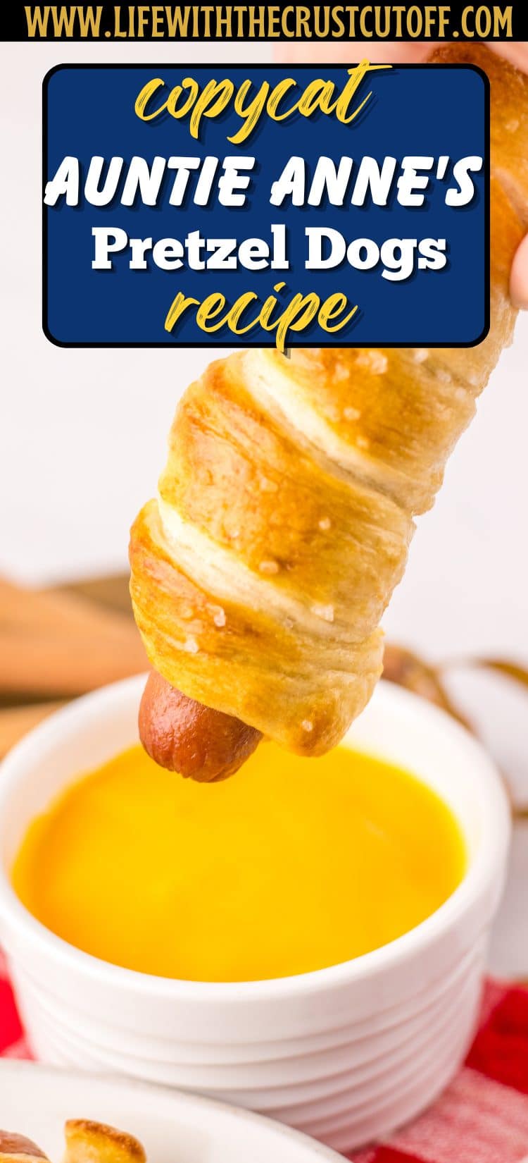 Golden brown pretzel-wrapped hot dogs sprinkled with coarse salt on a tray.