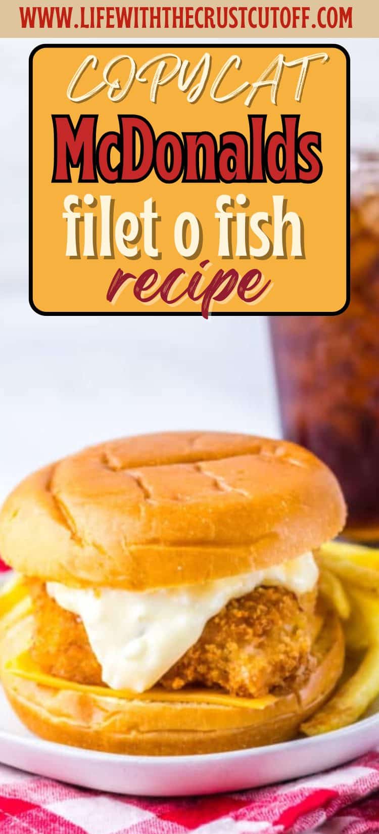 Homemade fish sandwich on a soft bun with tartar sauce and cheese.