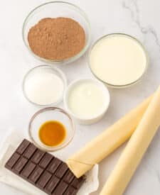 Ingredients for easy French silk slab pie laid out in bowls on white background