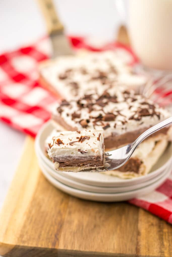 Creamy layered French silk pie slice with chocolate filling and flaky crust