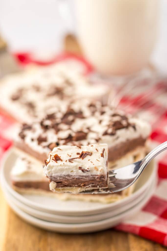 Creamy layered French silk pie slice with chocolate filling and flaky crust