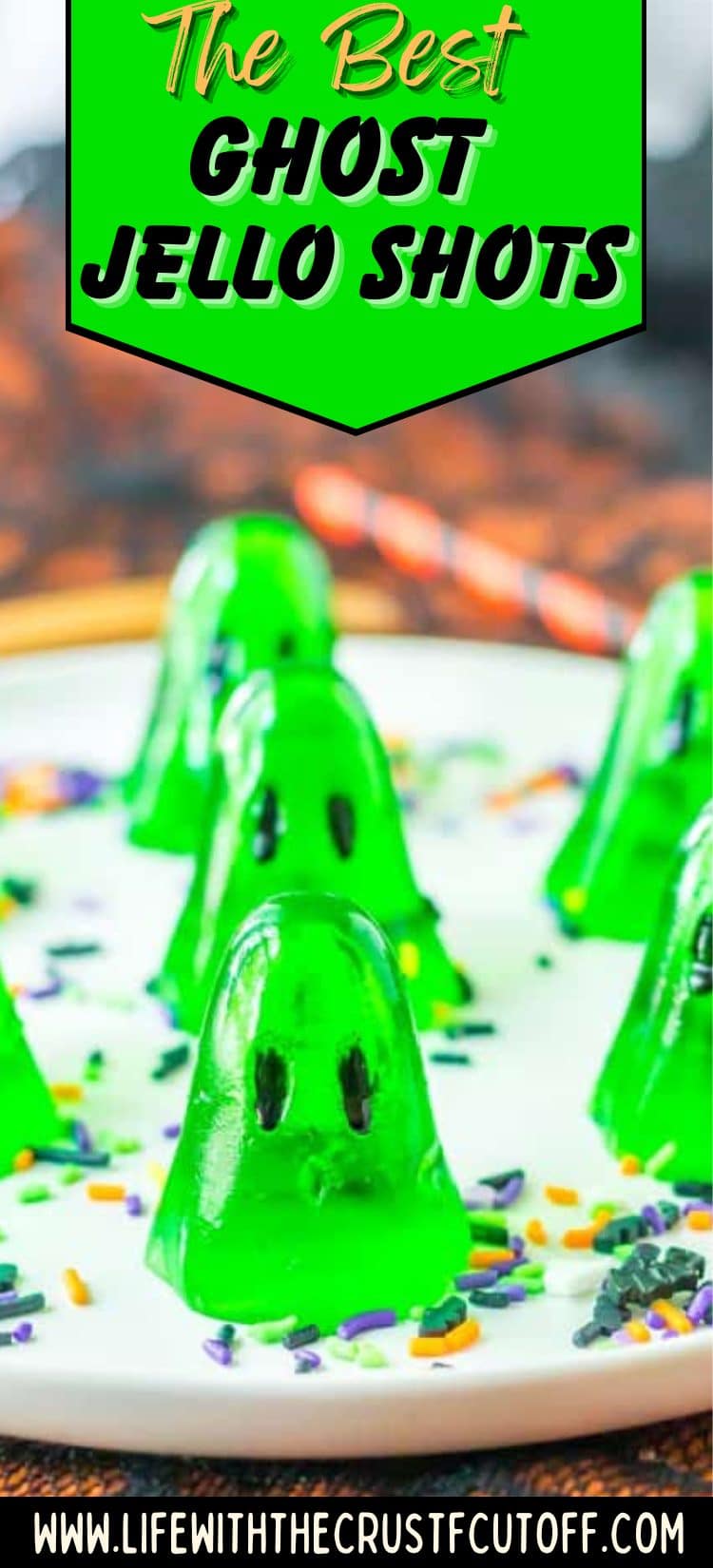 Ghost jello shots made with green apple gelatin, set in ghost molds and topped with painted faces.