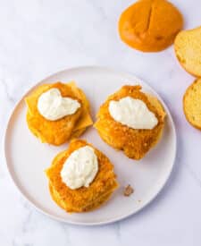Copycat Filet-O-Fish sandwiches topped with melted cheese and tartar sauce on buns.