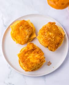 Plate of breaded fish fillets cooked golden brown.