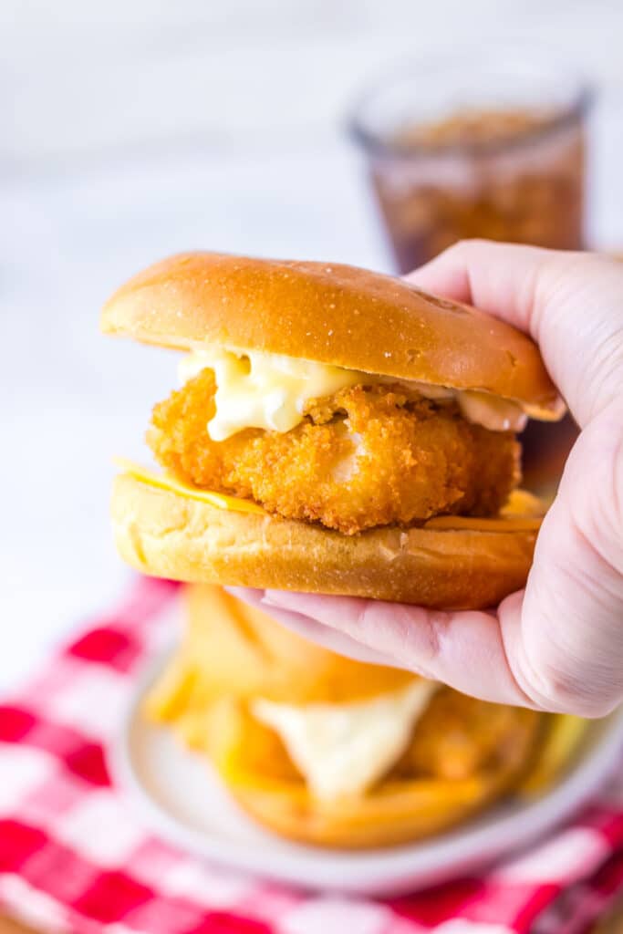 Close-up of crispy Filet-O-Fish sandwich with tartar sauce and melted cheese.