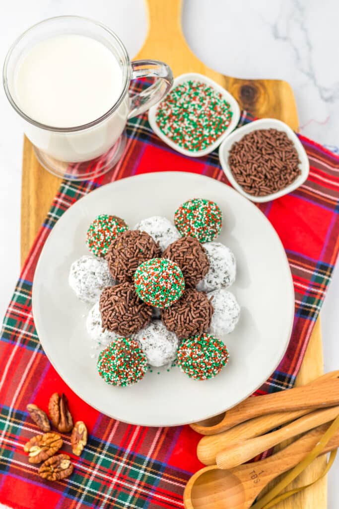 Overhead view of bourbon balls arranged on a tray with different coatings.