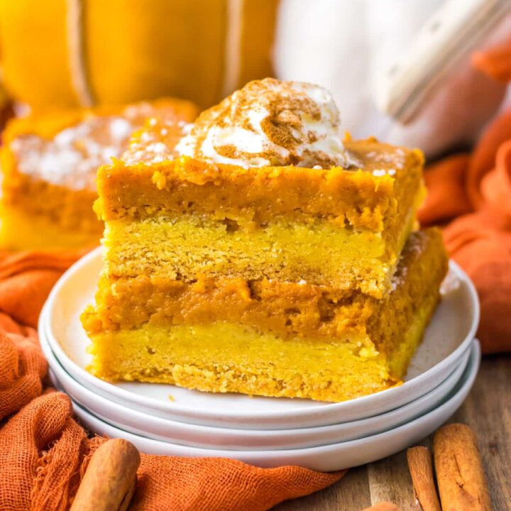 11. Pumpkin gooey butter bar slice stacked with layers of crust and pumpkin filling visible.