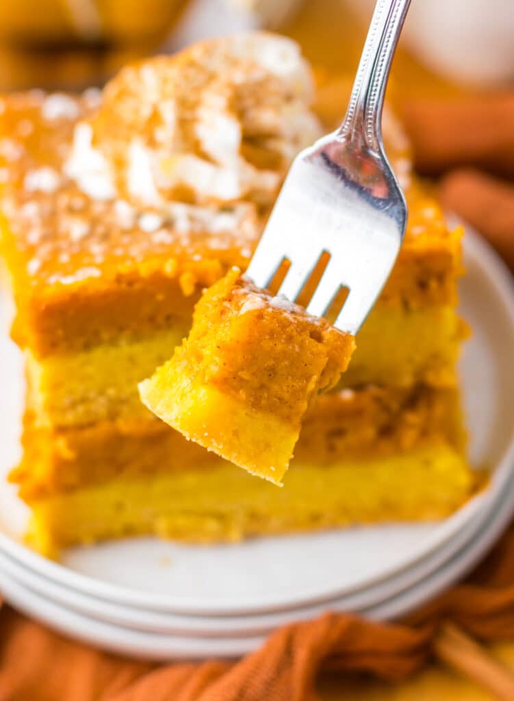 12. Fork holding a bite of pumpkin gooey butter bar.