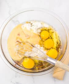 Mixing bowl with eggs, flour, and apple butter being whisked together for Apple Butter Pie filling.
