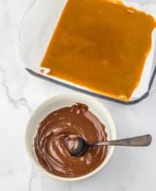 Golden sheet of classic English toffee cooling on parchment paper before adding chocolate and nuts