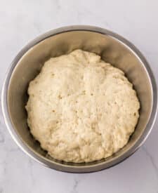 Pretzel dough fully risen and smooth in the bowl.