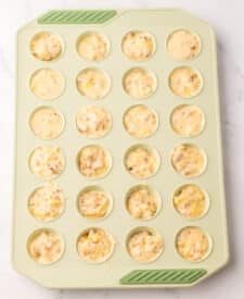 Mini McGriddle bite batter spooned into silicone mini muffin pan