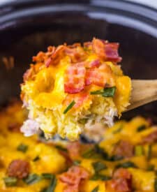Scoop of creamy chicken bacon ranch casserole showing melted cheese and golden tater tots.