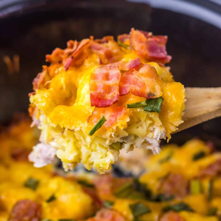 Scoop of creamy chicken bacon ranch casserole showing melted cheese and golden tater tots.