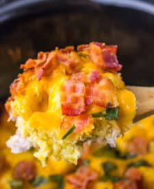 Scoop of creamy chicken bacon ranch casserole showing melted cheese and golden tater tots.