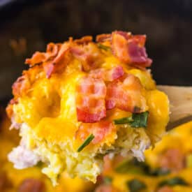 Scoop of creamy chicken bacon ranch casserole showing melted cheese and golden tater tots.
