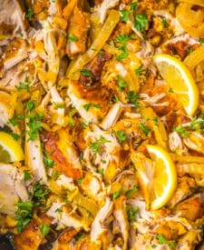 Close-up of slow cooker chicken shawarma simmering with lemon slices and warm spices