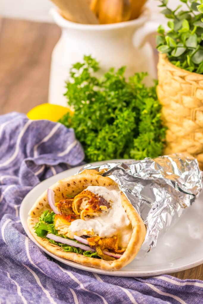 Slow Cooker Chicken Shawarma in pita with lettuce, tomato, and yogurt sauce