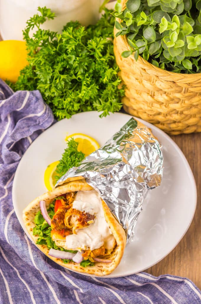 Slow Cooker Chicken Shawarma in pita with lettuce, tomato, and yogurt sauce