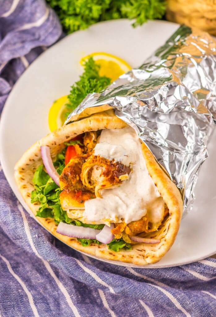 Slow Cooker Chicken Shawarma in pita with lettuce, tomato, and yogurt sauce