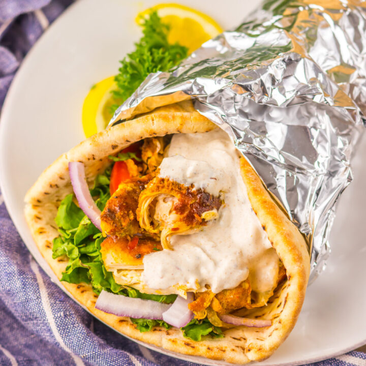 Slow Cooker Chicken Shawarma in pita with lettuce, tomato, and yogurt sauce
