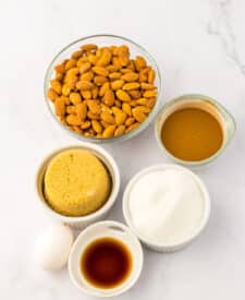 Ingredients for cinnamon almonds including whole almonds, cinnamon, sugars, egg white, vanilla, and water.