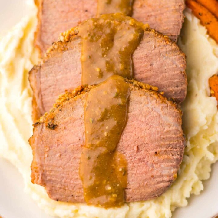 Thin slices of eye of round roast served with mashed potatoes and brown gravy.