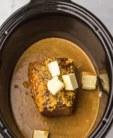 7. Eye of round roast in slow cooker topped with butter and garlic.