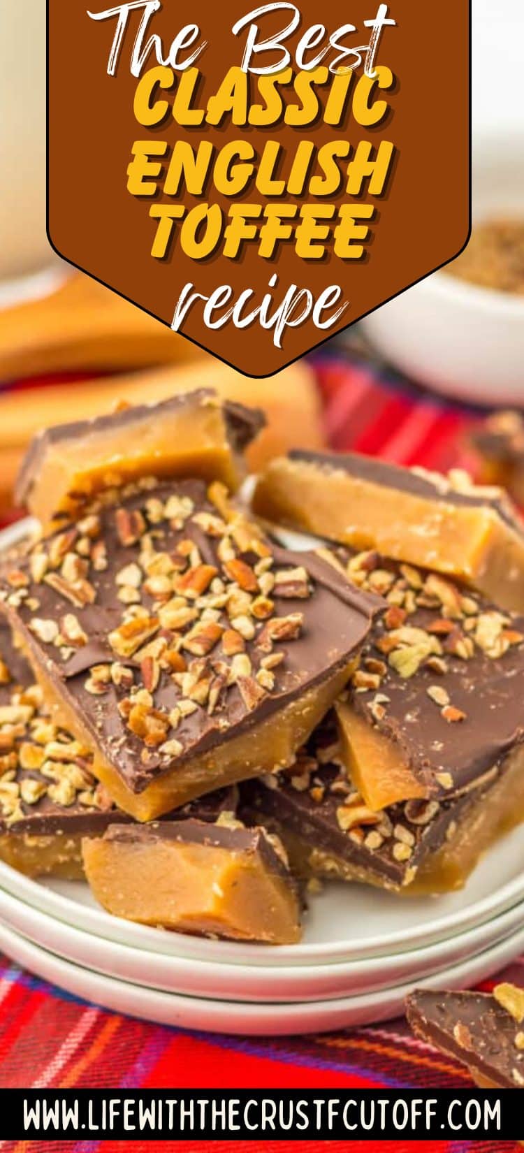 Pieces of classic English toffee with chocolate and chopped almonds on parchment paper.