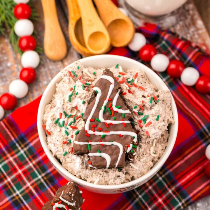 Overhead shot of Chocolate Christmas Tree Cake Dip surrounded by Christmas treats and sprinkles