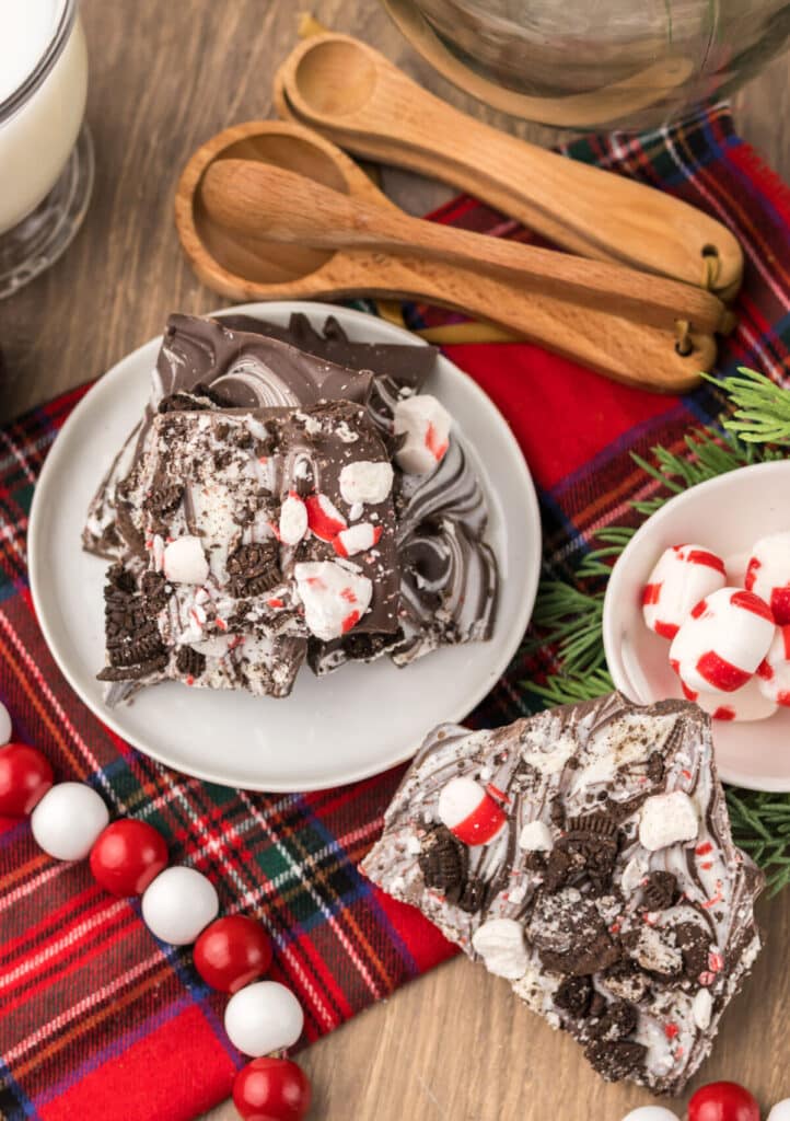 Peppermint Oreo Bark on a white plate with plaid background