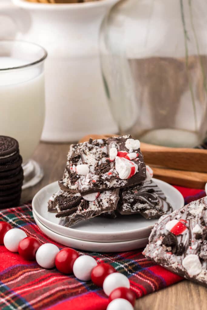 Peppermint Oreo Bark on a white plate with plaid background