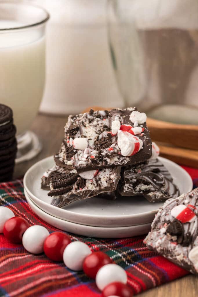 Peppermint Oreo Bark on a white plate with plaid background