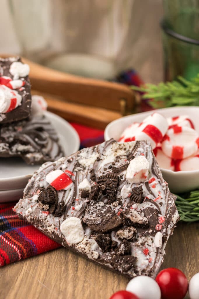 Close up of Peppermint Oreo Bark on a white plate with plaid background