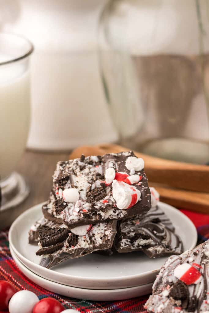 Peppermint Oreo Bark on a white plate with plaid background