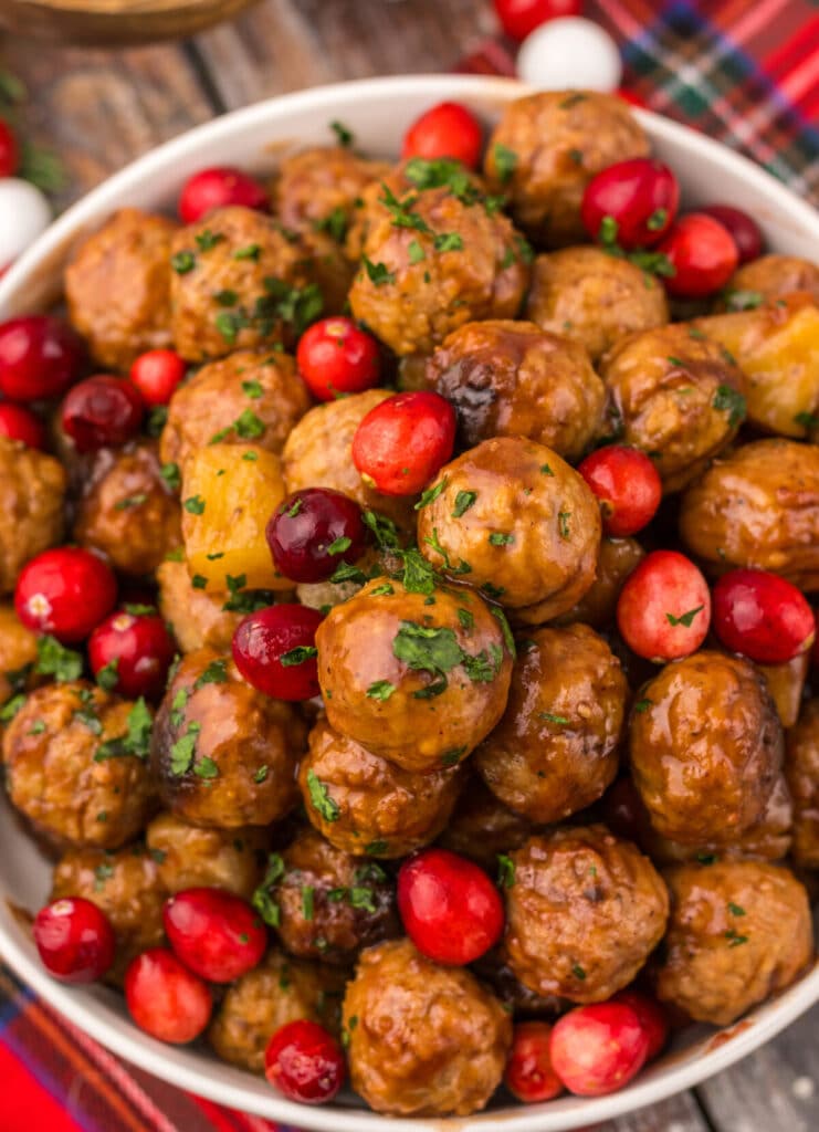 Close-up of juicy Slow Cooker Cranberry Pineapple Meatballs coated in sticky cranberry sauce