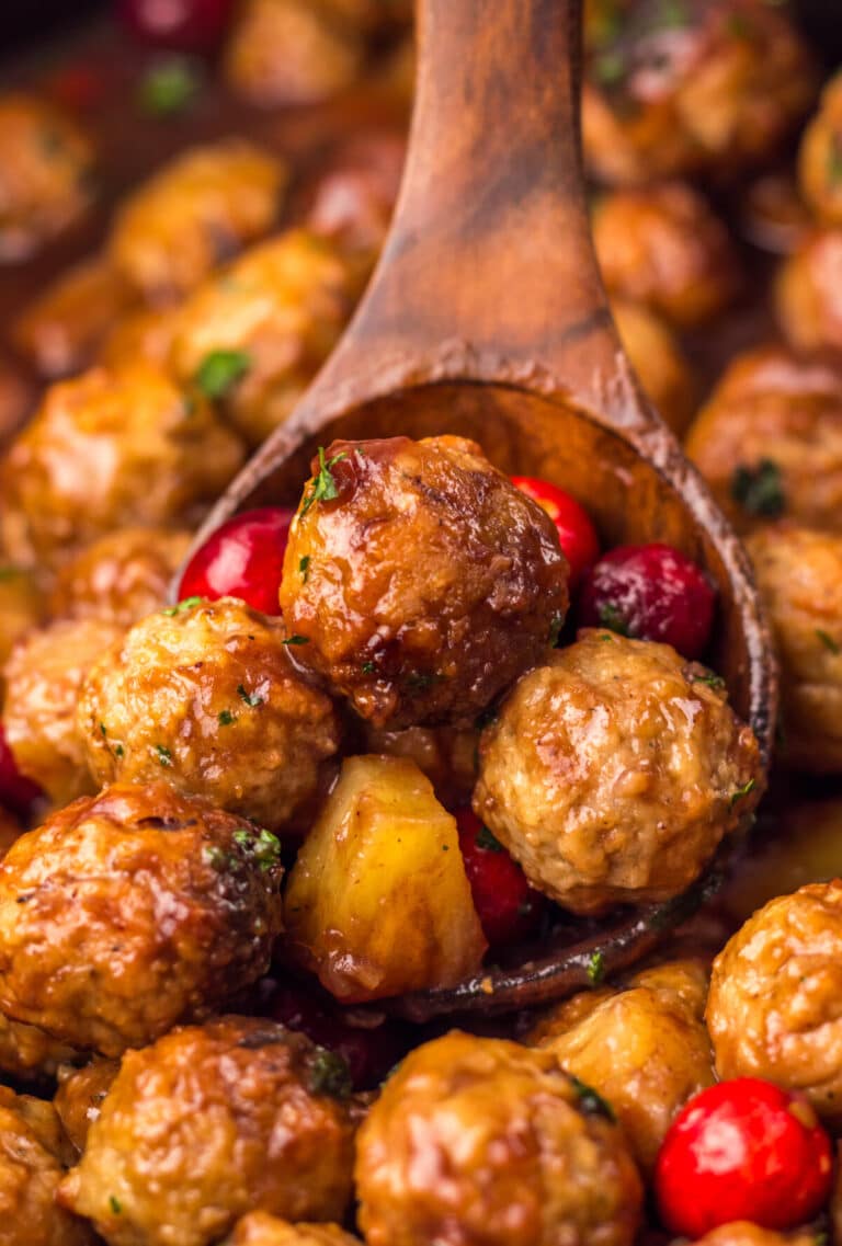 Close-up of Slow Cooker Cranberry Pineapple Meatballs glistening in rich cranberry glaze with pineapple chunks