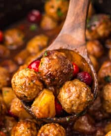 Close-up of Slow Cooker Cranberry Pineapple Meatballs glistening in rich cranberry glaze with pineapple chunks