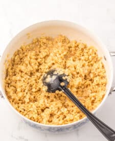 Melted butter and marshmallows in a saucepan being stirred together to make Sugar Cookie Rice Krispie Treats