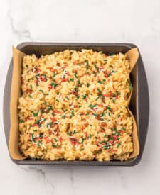Tray of soft and chewy Sugar Cookie Rice Krispie Treats with melted marshmallows and sprinkles.