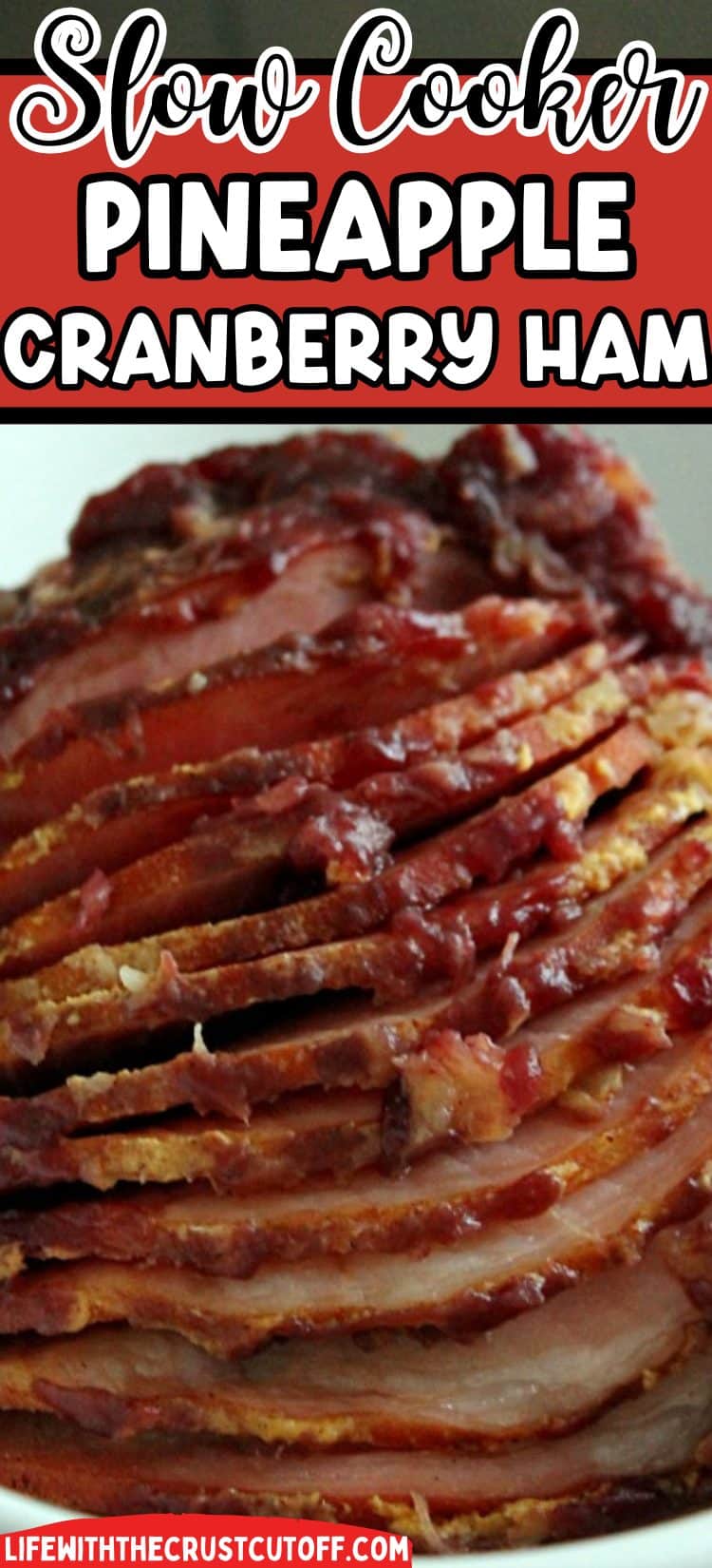 Slow cooker ham glazed with pineapple and cranberry sauce, sliced on a holiday platte