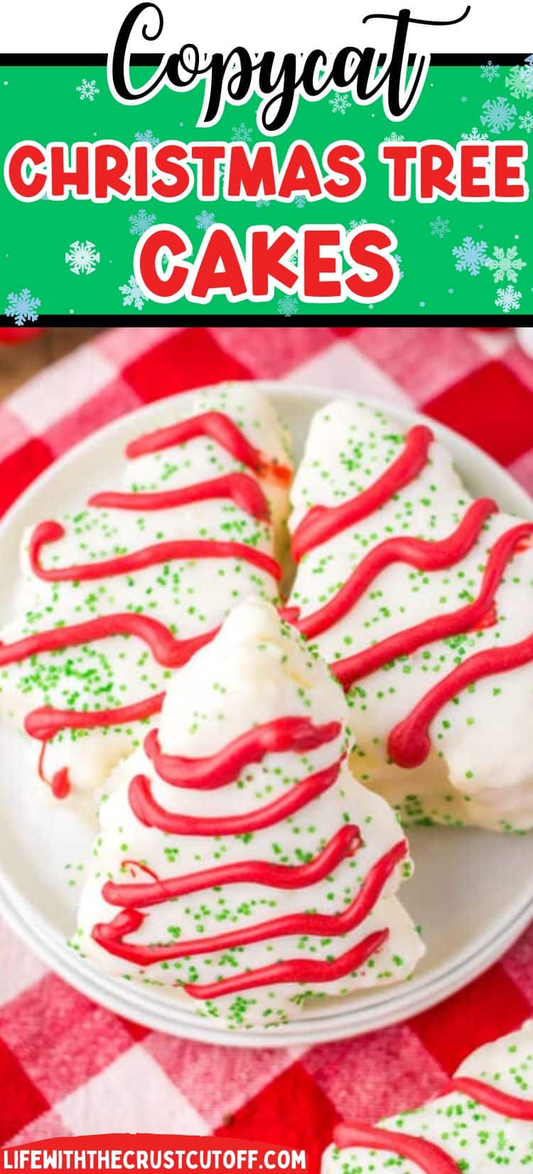 Homemade copycat Christmas tree cakes dipped in white coating with red drizzle and green sprinkles on parchment