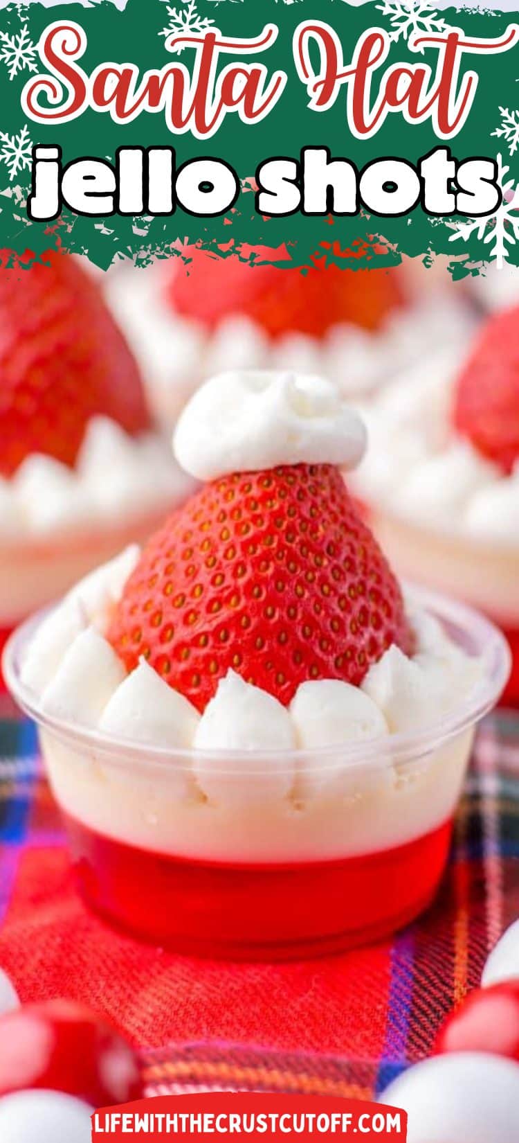 Festive Santa-hat shaped jello shots topped with whipped cream and fresh strawberries