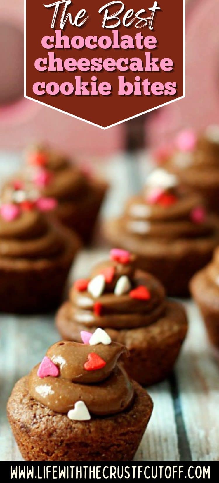 Chocolate cheesecake cookie bites topped with creamy chocolate filling and heart sprinkles on a rustic surface