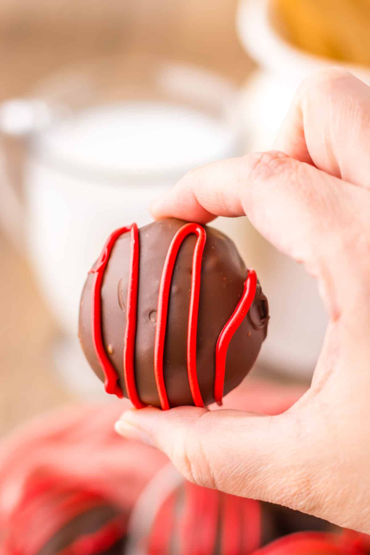 Raspberry brownie bombs served alongside a glass of milk.
